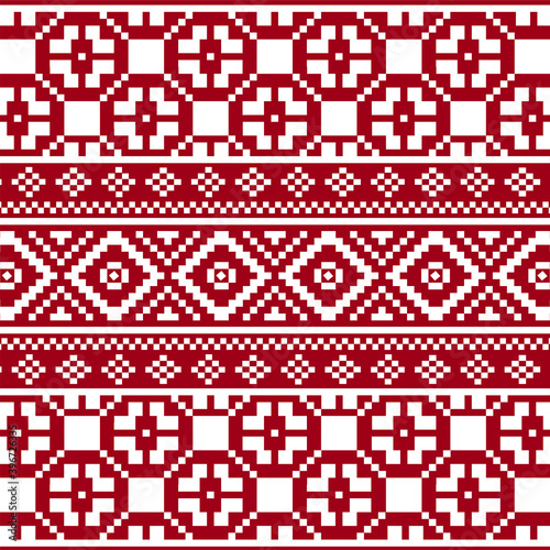 Knitted seamless pattern in red with snowflakes.