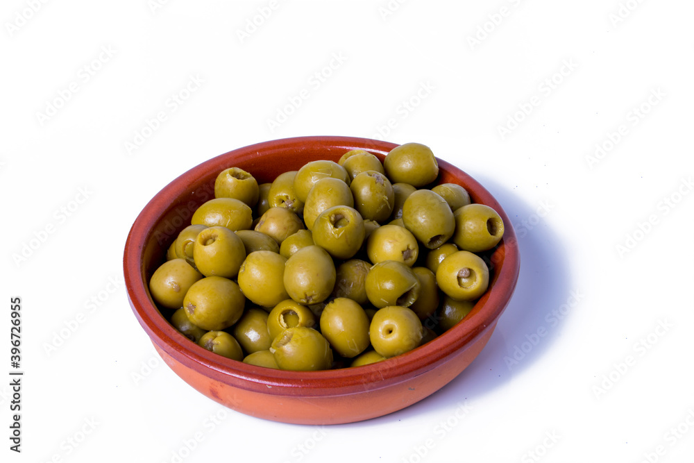 Olives stuffed with anchovies in a ceramic bowl and white background Olives stuffed with anchovies in a ceramic bowl and white background