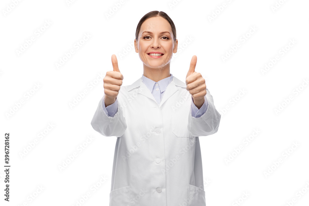 medicine, profession and healthcare concept - happy smiling female doctor in white coat showing thumbs up medicine, profession and healthcare concept - happy smiling female doctor in white coat showing thumbs up