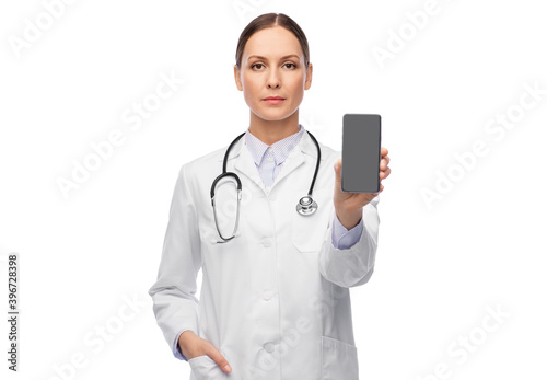 medicine  profession and healthcare concept - female doctor or nurse with stethoscope showing smartphone over white background
