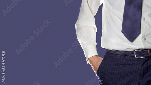 Man in blue pants and white shirt close up on blue background