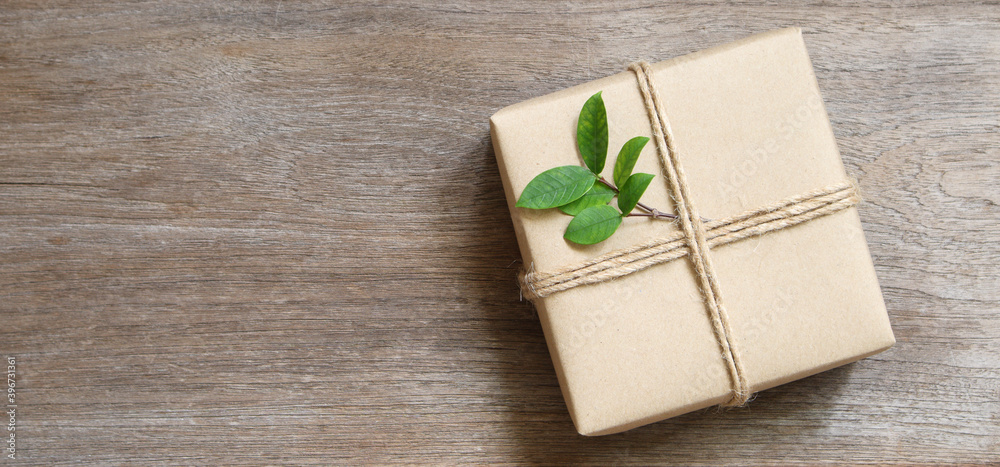 gift box wrapped in recycled paper with rope and leaf on wood background with copy space for text or image / green concept
gift box wrapped in recycled paper with rope and leaf on wood background with copy space for text or image / green concept