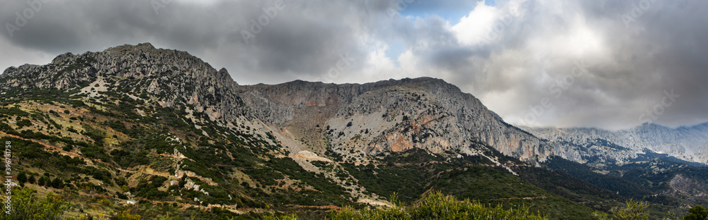 Mount Parnassus with green hills and cloudy moody skies, scenic background.