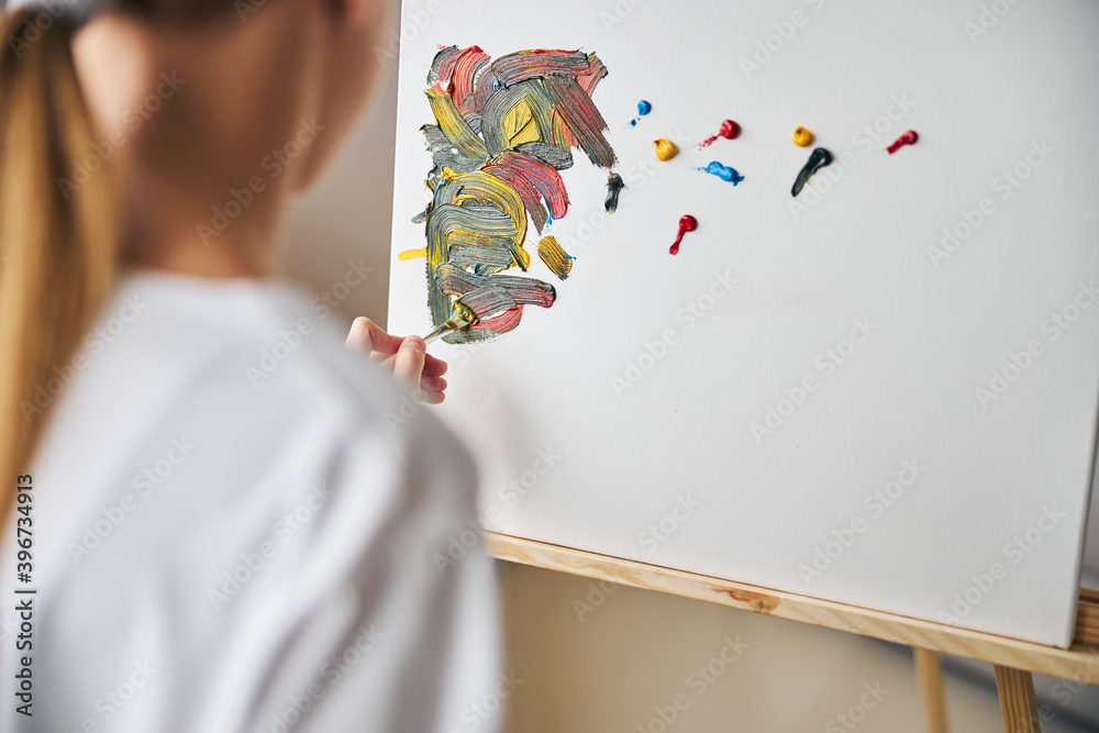 Beginner artist blending acrylic paints on the canvas Beginner artist blending acrylic paints on the canvas
