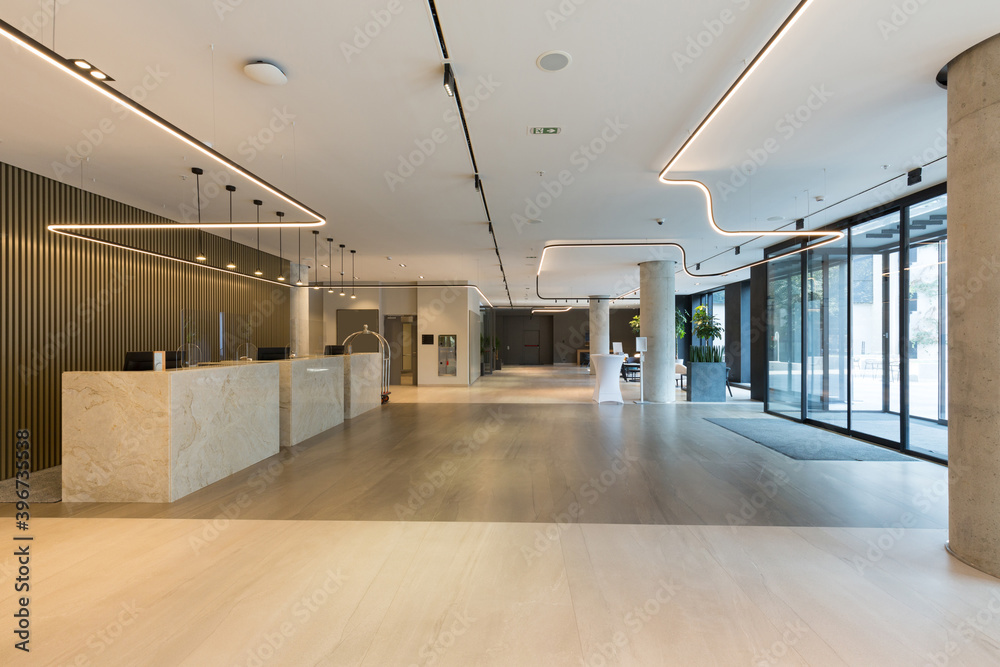 Interior of a hotel lobby with reception desks with transparent