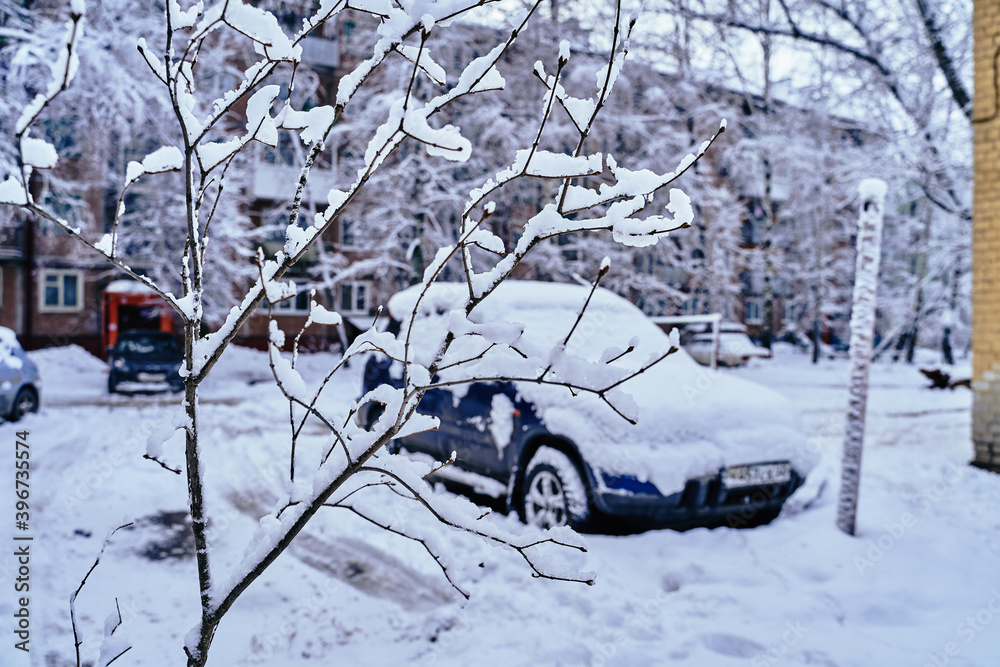 Snow-covered car in the yard. It snowed at night. Snow-covered car in the yard. It snowed at night.