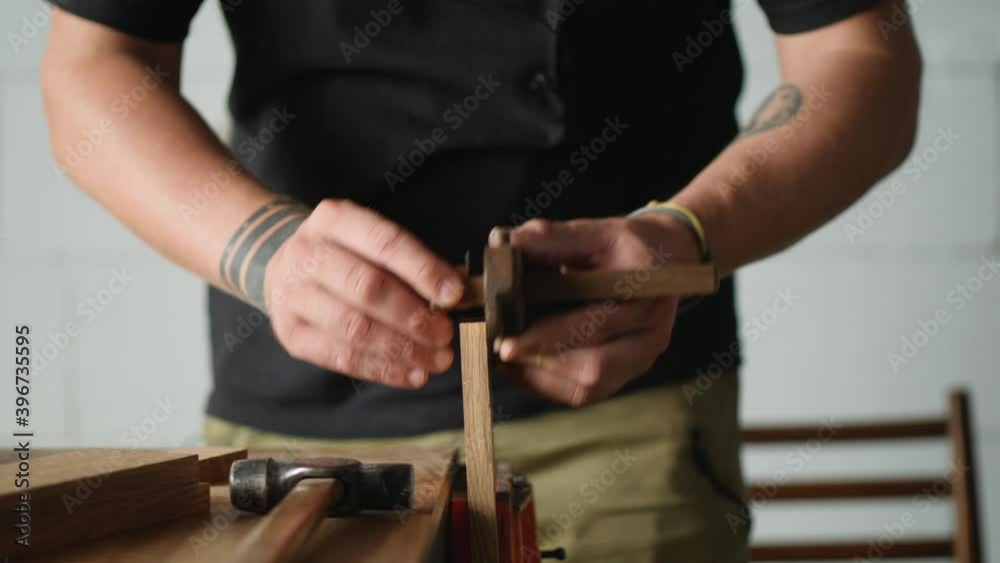 a woodworker makes the markings on the oak blank using marking gauge. handmade carpentry. the sound of carpentry tools