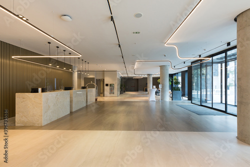 Interior of a hotel lobby with reception desks with transparent coronavirus guards
