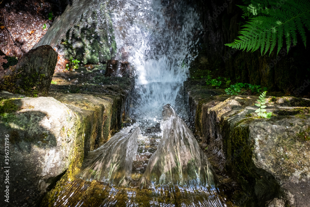 Fototapeta premium Water jet falling over a stone dam of water reservoir.