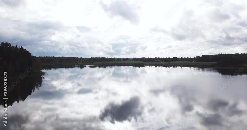 Mirror like lake reflecting the cloudy sky Mirror like lake reflecting the cloudy sky