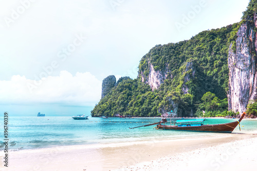 Fototapeta Naklejka Na Ścianę i Meble -  Long tail boat park on the beach with have turquoise sea blue sky at Koh Hong lagoon,Krabi south of Thailand.