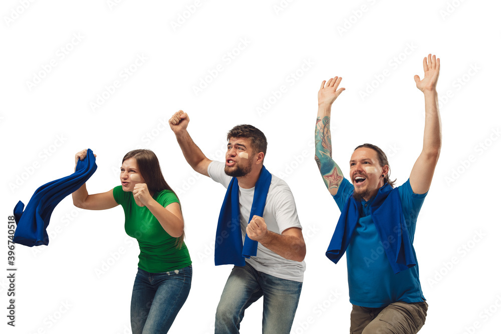Victory. Three soccer fans woman and men cheering for favourite sport team with bright emotions isolated on white studio background. Looking excited, supporting. Concept of sport, fun, support. Victory. Three soccer fans woman and men cheering for favourite sport team with bright emotions isolated on white studio background. Looking excited, supporting. Concept of sport, fun, support.