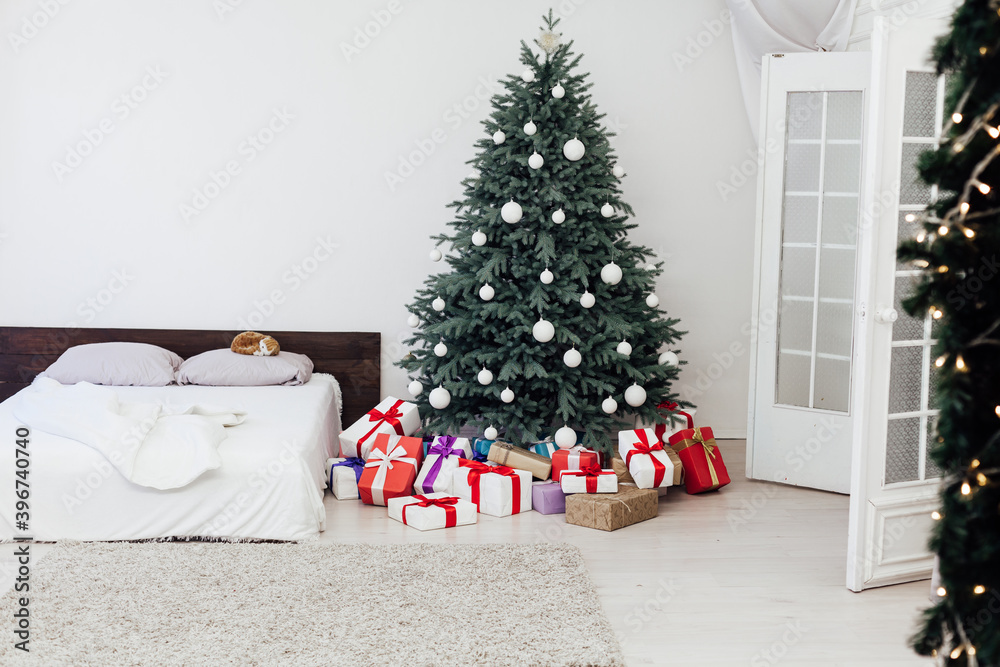 bedroom with bed decor new year and beautiful Christmas tree with gifts