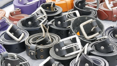 Wallpaper Mural Leather belts in black and blue on the open-air market counter. Torontodigital.ca
