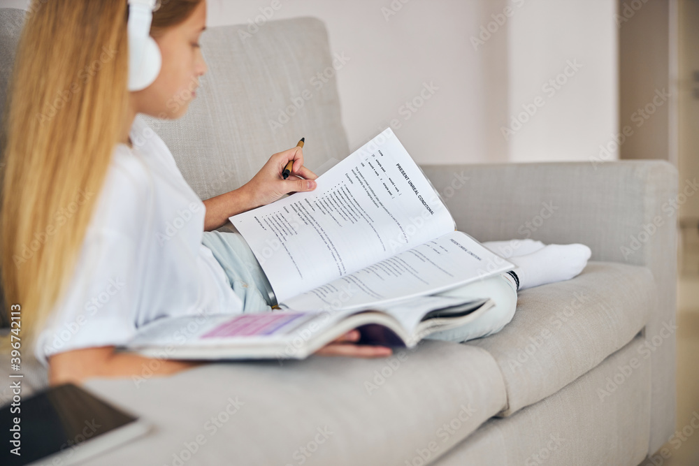 English student learning present conditional with headphones on English student learning present conditional with headphones on