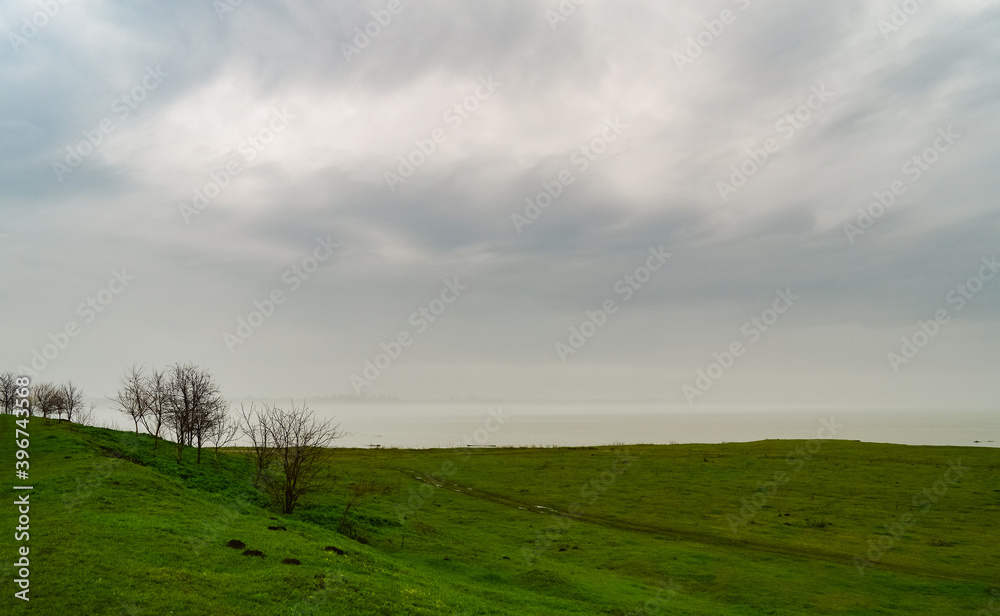 The far bank of the river is lost in the fog The far bank of the river is lost in the fog