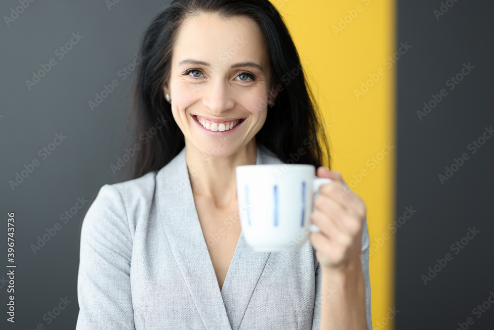 Smiling woman holding white mug in her hands. Smiling woman holding white mug in her hands.