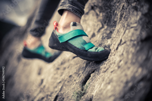 Person climbing while wearing rock climbing shoes