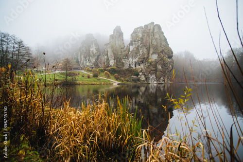 Externsteine rock formation, also called German Stonehenge, in the Teutoburg Forest, Germany. Fog photo