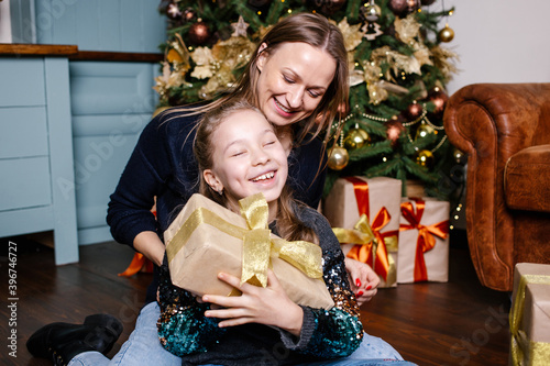 girl receives christmas gift from mother
