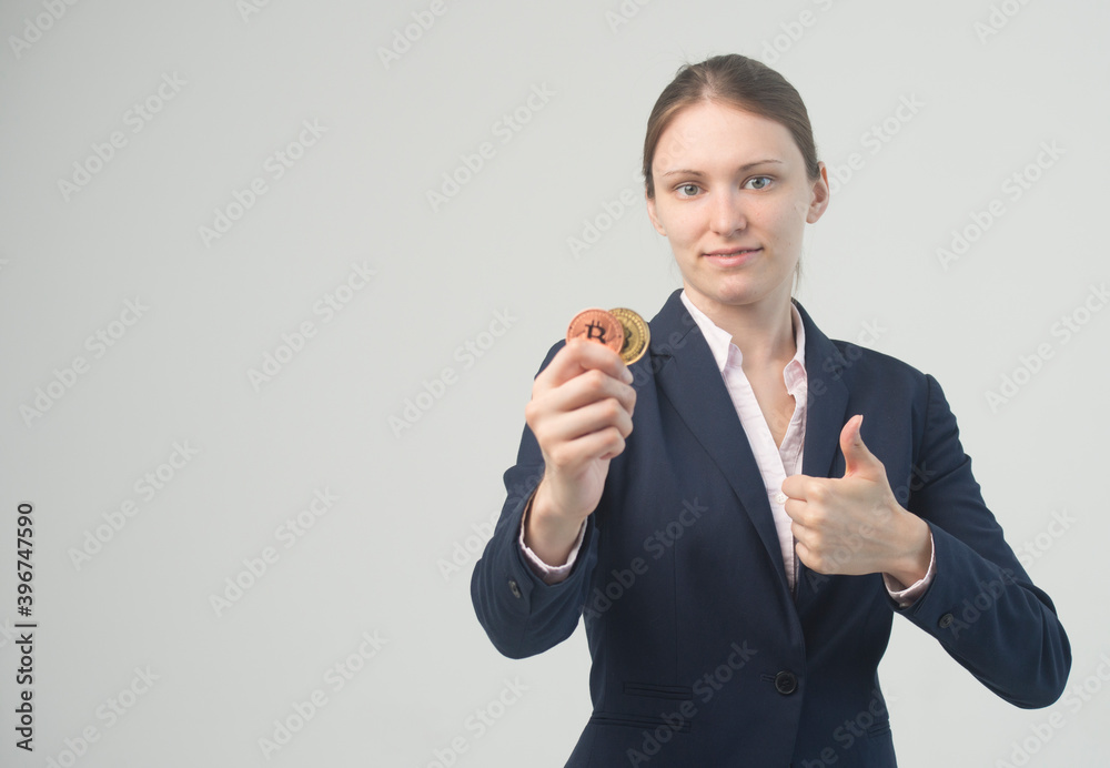 Woman holding a physical bitcoin cryptocurrency in her hand Woman holding a physical bitcoin cryptocurrency in her hand