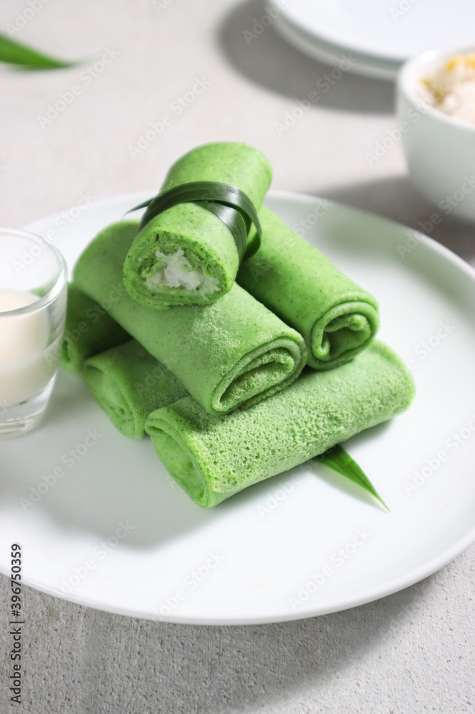 Dadar Gulung or Dadar Unti is Indonesian traditional finger food (jajan pasar), is grated coconut sweetened with palm sugar wrapped in pandan crepes.