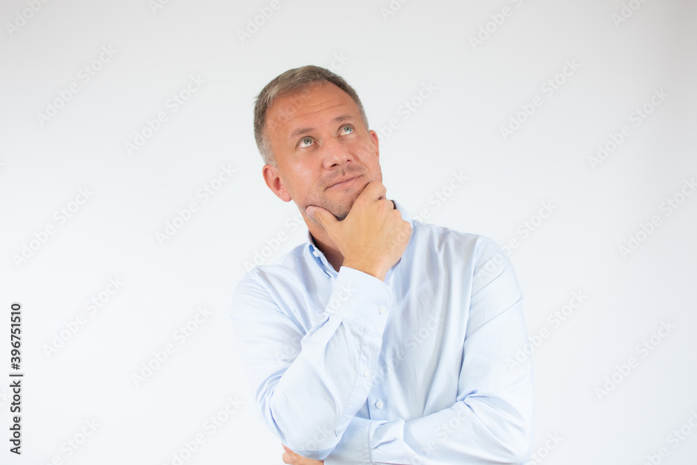 Young man in casual shirt thinking over white background. Young man in casual shirt thinking over white background.