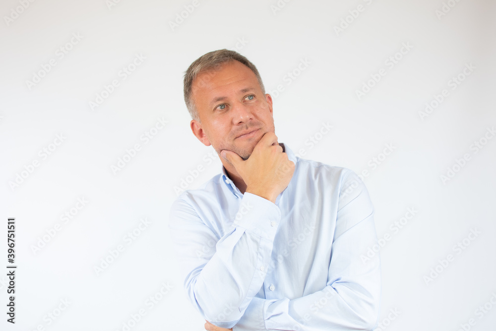 Young man in casual shirt thinking over white background. Young man in casual shirt thinking over white background.