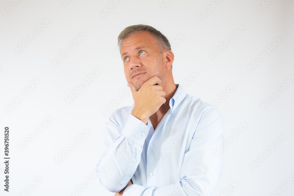 Young man in casual shirt thinking over white background. Young man in casual shirt thinking over white background.