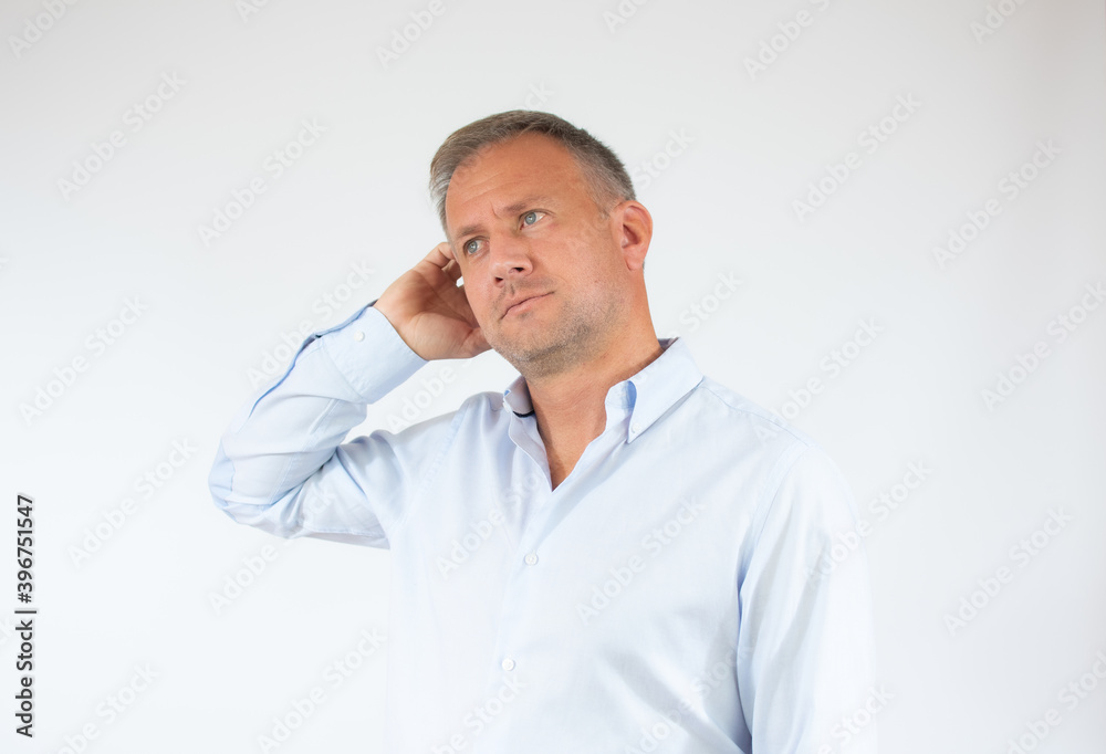 Young man in casual shirt thinking over white background. Young man in casual shirt thinking over white background.