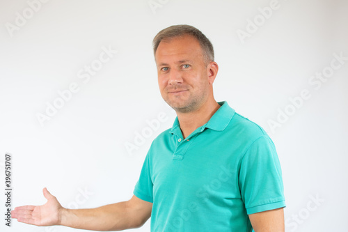 Man in casual t-shirt pointing space over white background
