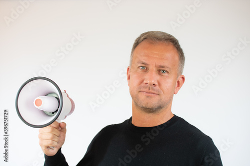Young man holding a megaphone on white background
