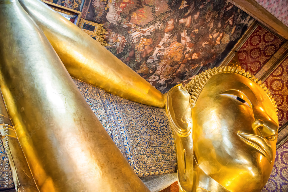 Panorama of large golden statue of Reclining Buddha in temple Wat Pho. Bangkok, Thailand