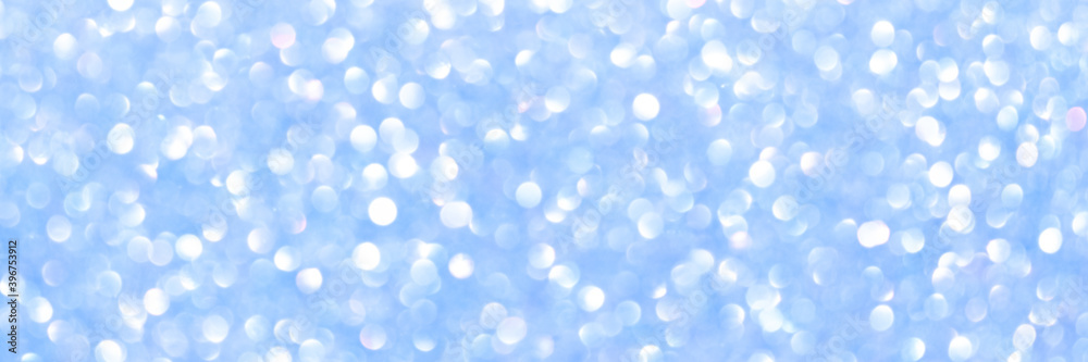 An abstract blue background with sparkle lights and bokeh. Useful as Christmas background or greeting card.