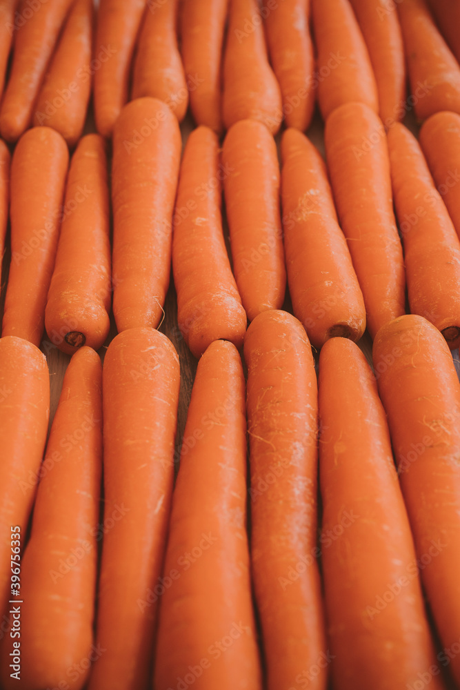 Close up view of organic carrots as background at the market. Vegetarian food concept. Close up view of organic carrots as background at the market. Vegetarian food concept.