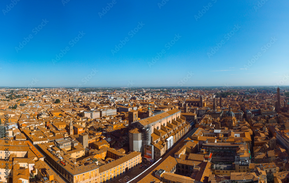 Aerial view of Basilica di San Petronio, Bologna, Italy at sunset. Colorful sky over the historical city center with car traffic and old buildings roofs. Travel and vacation concept. Italy, Europe