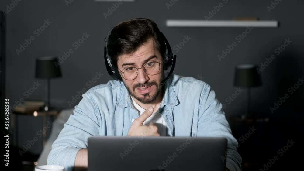Young business man using laptop video conference talking to colleagues meeting online work from home quarantine during Coronavirus pandemic Young business man using laptop video conference talking to colleagues meeting online work from home quarantine during Coronavirus pandemic