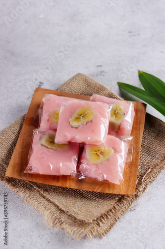 Nagasari, Indonesian traditional steamed snack made from hunkwe flour, coconut milk and sugar. Filled with sliced of banana photo