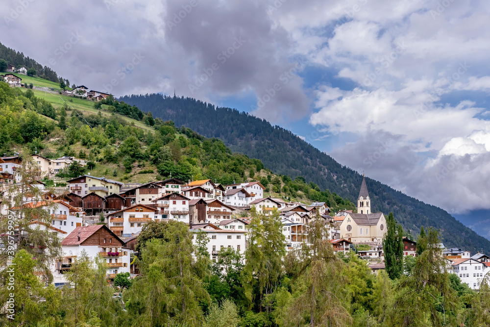 Panoramic view of the town of Stelvio, South Tyrol, Italy, with a dramatic sky in the background