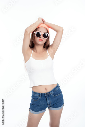 Obraz na plátne Beautiful asian woman in short jeans, isolated on white background