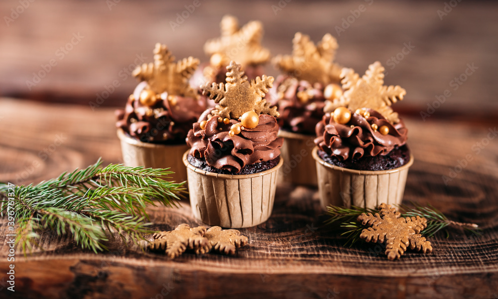 Chocolate cupcakes with star shaped cookies on a wooden background. Christmas mood. Sweets for any occasion Chocolate cupcakes with star shaped cookies on a wooden background. Christmas mood. Sweets for any occasion