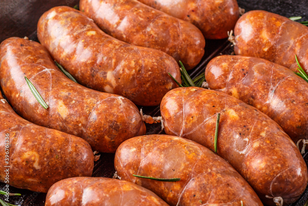 Grilled sausages, homemade,cast iron skillet or frying pan with tomatoes, garlic and rosemary. Brazilian barbecue. copy space Grilled sausages, homemade,cast iron skillet or frying pan with tomatoes, garlic and rosemary. Brazilian barbecue. copy space