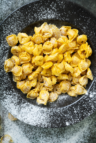Raw Uncooked Cappelletti with flour
