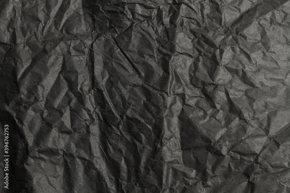 Fototapeta premium Fondo de textura de papel negro oscuro arrugado irregular. Vista de cerca