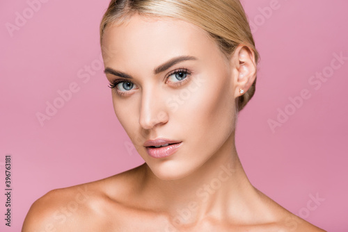 beautiful blonde woman with perfect skin isolated on pink