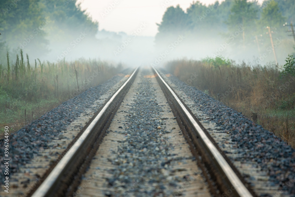On the tracks, an approaching train to cross On the tracks, an approaching train to cross
