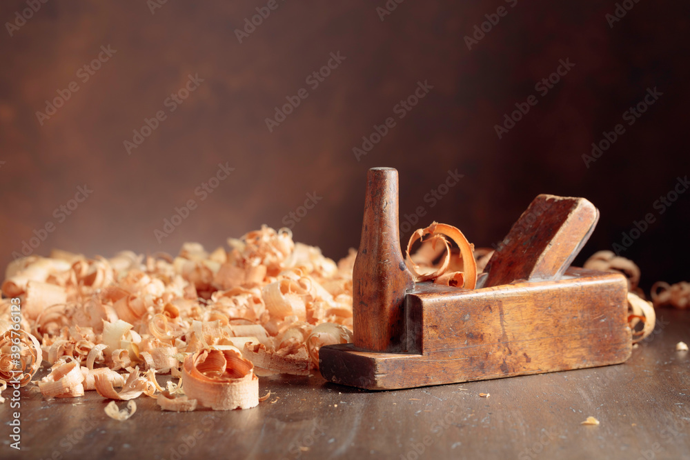 Old wooden jointer and shaving on wooden table. Old wooden jointer and shaving on wooden table.