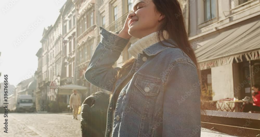 close up 4k shot of young dark haired woman walking down the street and exploring old beautiful city.Travel concept