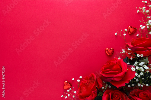 Valentine's day mock up with gypsophila, red ribbon and hearts isolated on red background. Copy space. © Inga