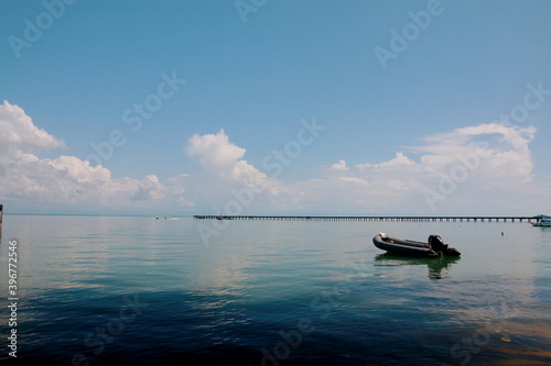 Bright sky with white clouds above the sea, for background.  © Chaleow